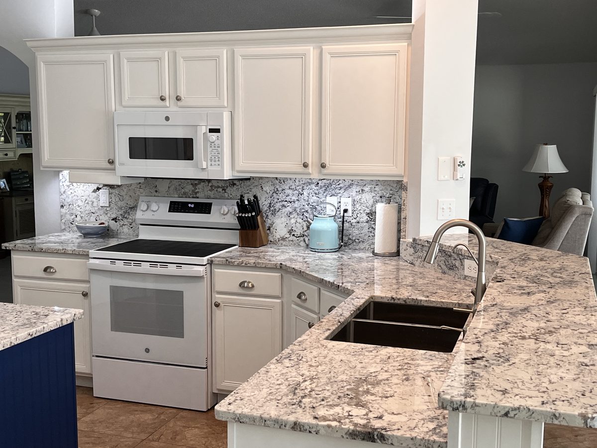 Kitchen after remodel with new cabinets, countertops and backsplash